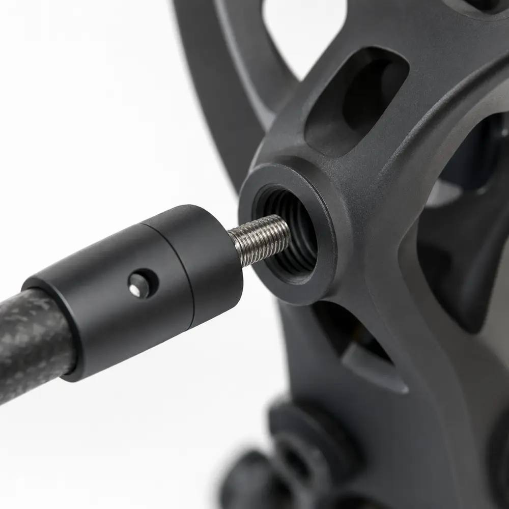 Close-up of the SteadyDraw universal threaded stud being screwed into a compound bow riser bushing